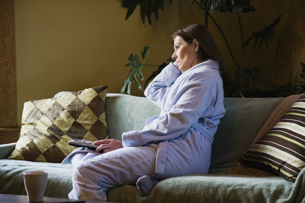 woman watching morning television wearing pajamas
