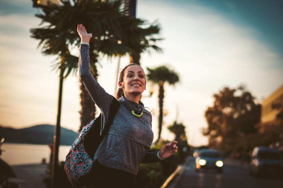 woman waving on the street