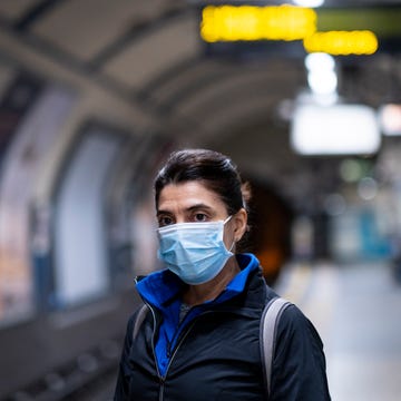 Woman wearing a mask on the London subway or tube woman wearing a mask on the london subway or tube