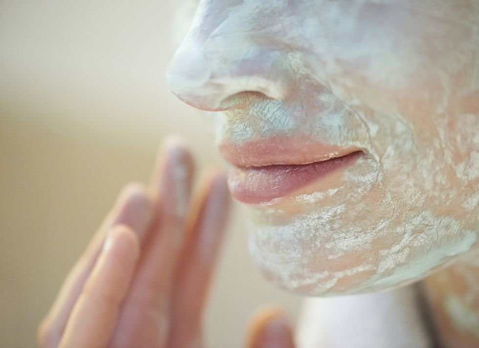 Woman wearing facial mask, close up of mouth