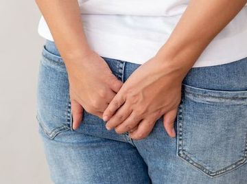 Woman wearing of jean pants from back, Female bottom and hemorrhoid symptoms from rectal cancer concept