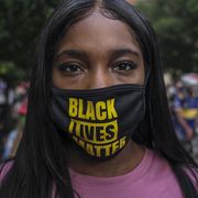 a woman wearing protective mask with black lives matter