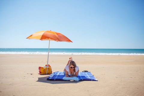 woman with book on beach