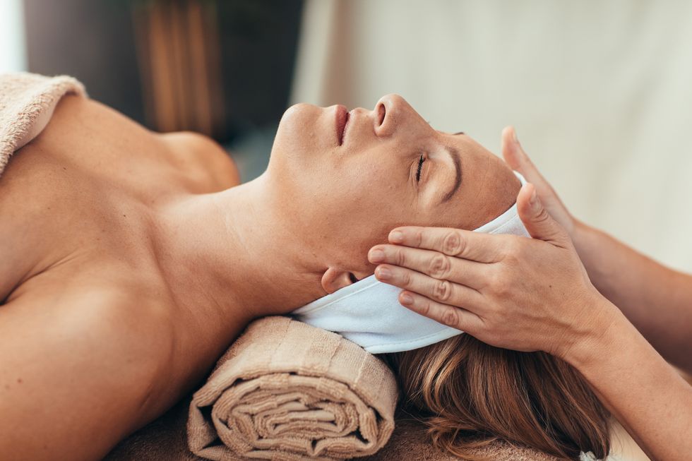 woman with closed eyes enjoy head massage