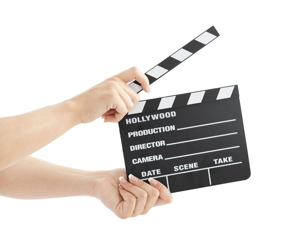 Woman with film clapper on white background