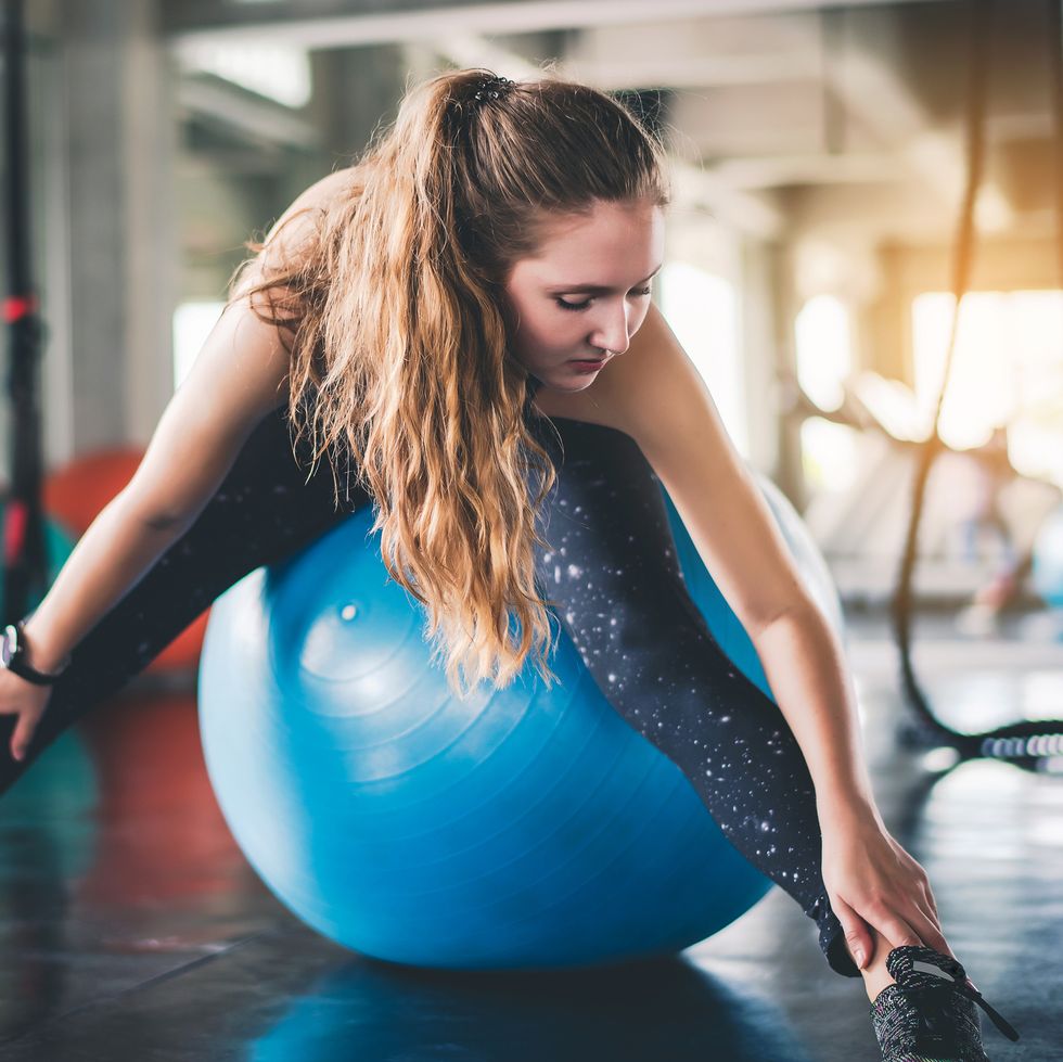 woman with fitness ball exercising in gym