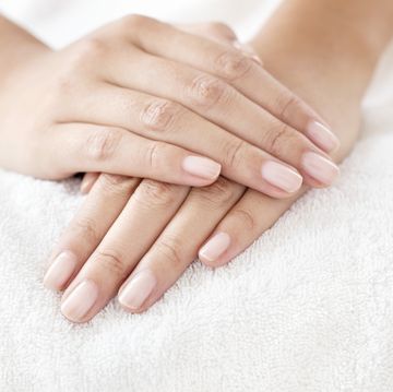 woman with hands resting on white towel
