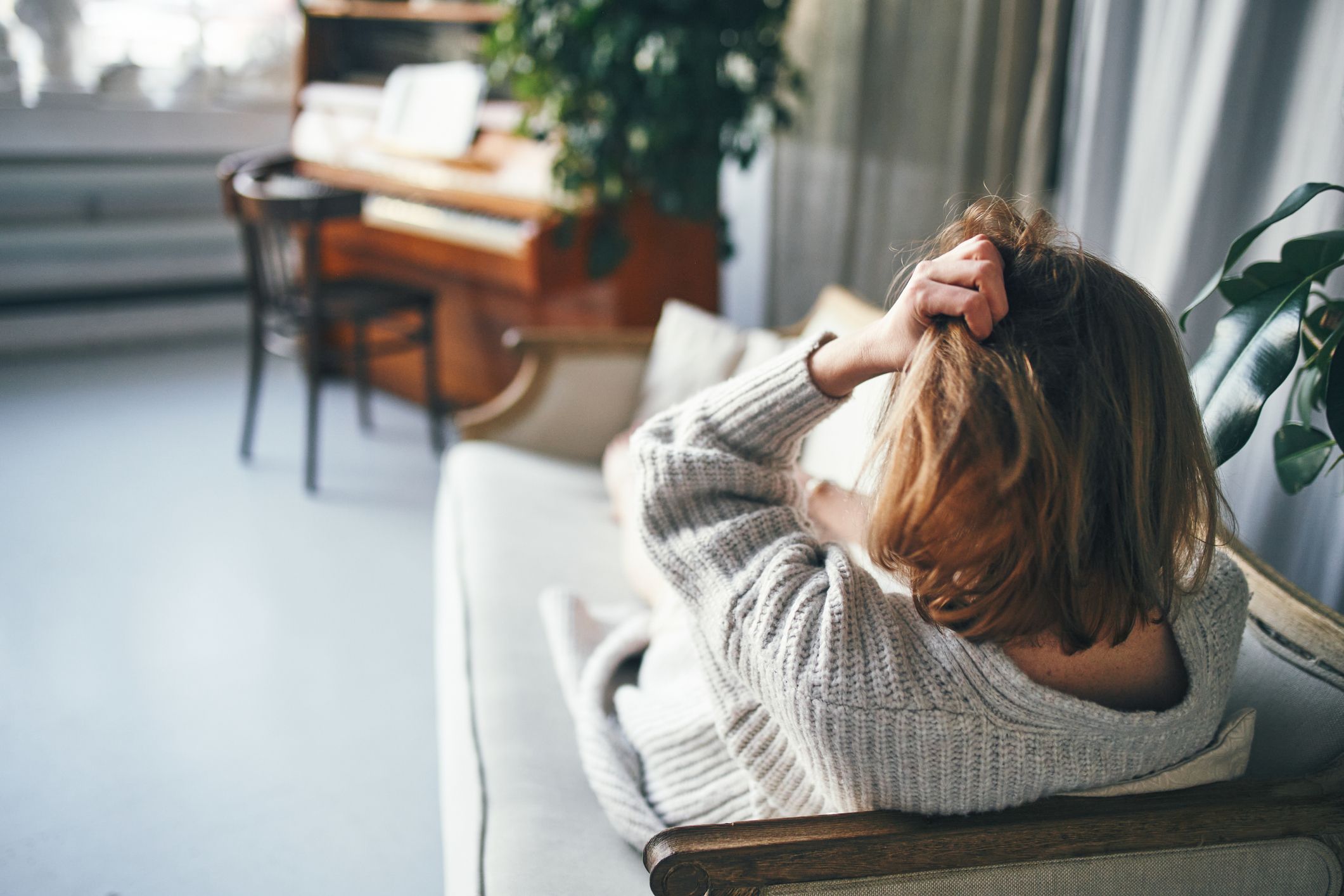 woman with her back to the camera is lying on a royalty free image