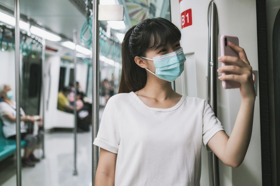 woman with mask in metro