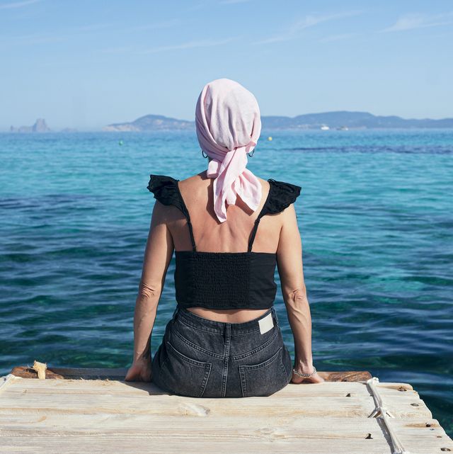 woman with pink headscarf, has cancer