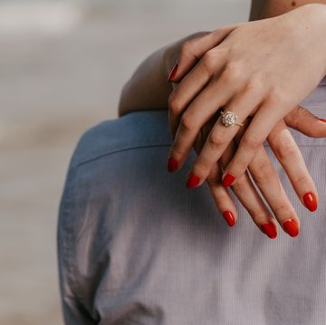 woman with red nails hugs man