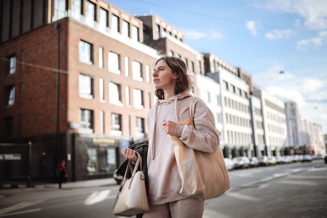 cityscape serenity: woman with sturge weber syndrome enjoys peaceful walk in urban setting.