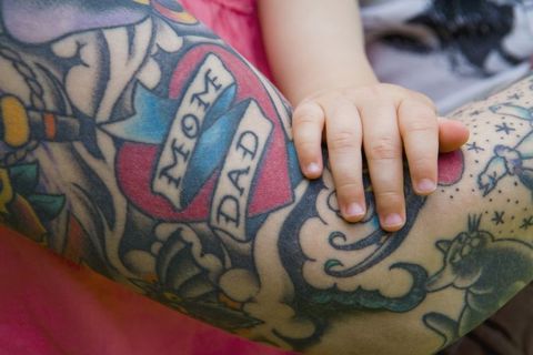 woman with tattoos and child