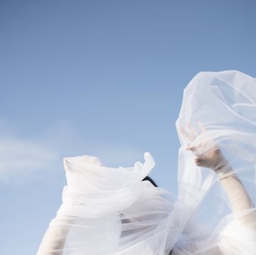 woman with white veil blowing over face