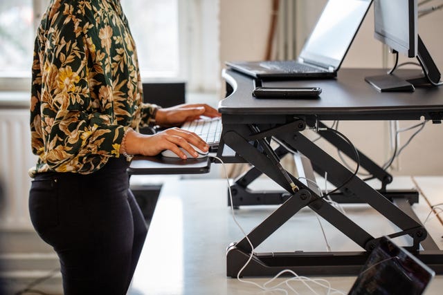 woman working at a standing desk in office