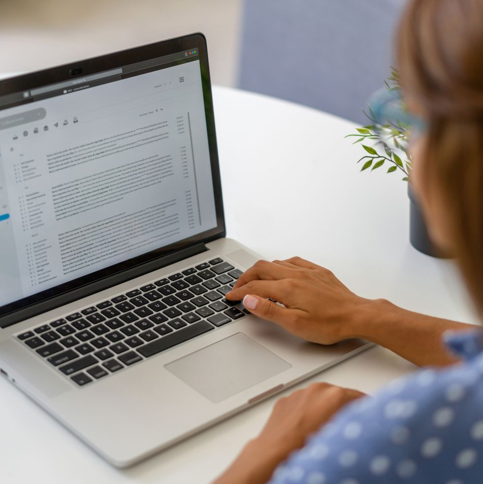 woman working at home and reading e mails on her laptop
