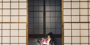 Woman working with tablet computer in a traditional ryokan