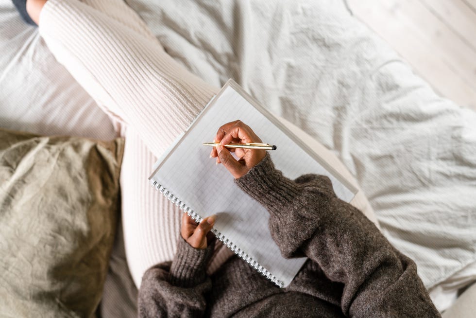 woman writing in bed