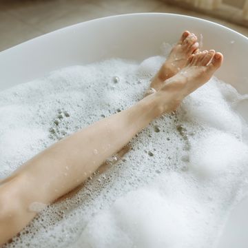 woman's feet in bubble bath