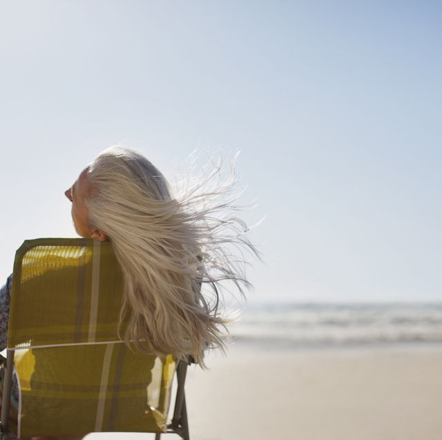 womans hair blowing in wind on beach