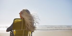 womans hair blowing in wind on beach