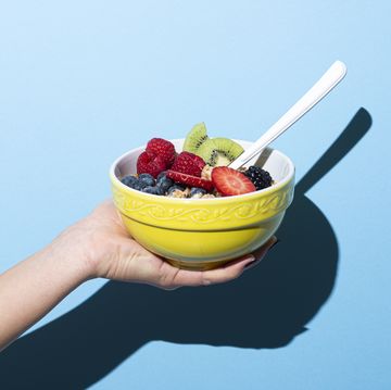 woman's hand holding bowl with muesli