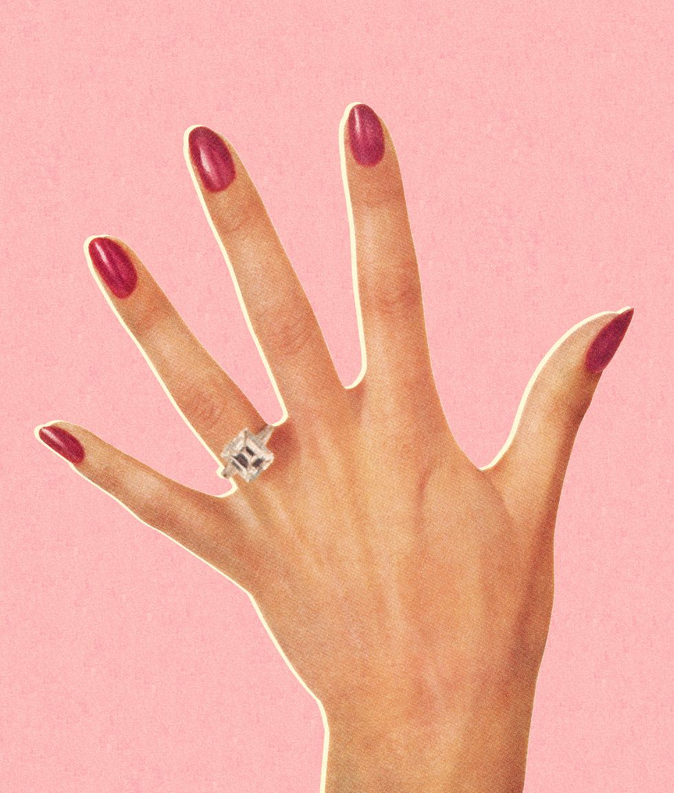 woman's hand wearing engagement ring