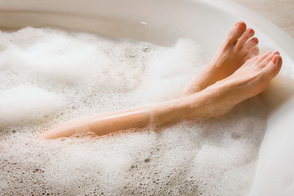 woman's legs feet in bubble bath