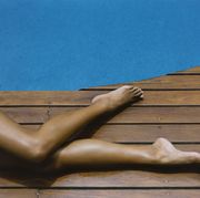 woman's legs on pool deck