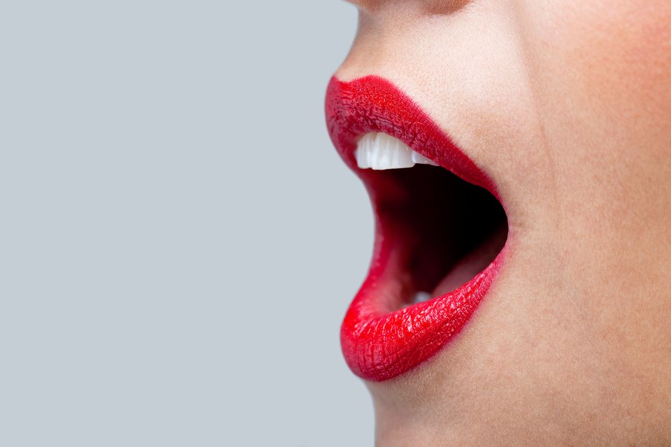 womans mouth wide open with red lipstick