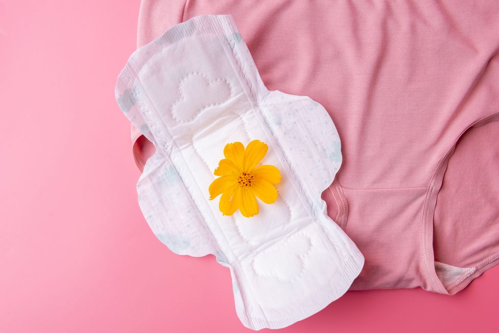 woman's panties and sanitary napkin on pink background, feminine hygiene health concept