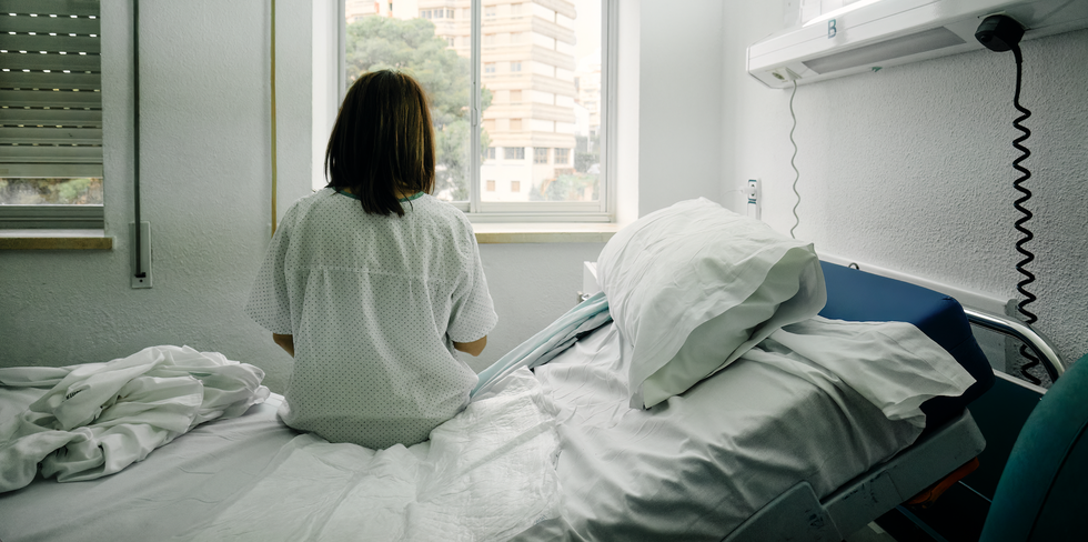 a woman sitting on a hospital bed