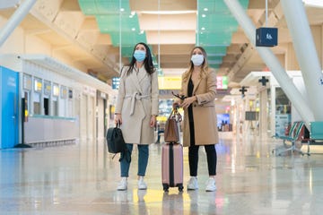 women at the airport in covid 19 time