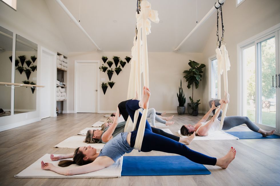 women doing aerial yoga at retreat