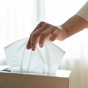 women hand picking napkintissue paper from the tissue box