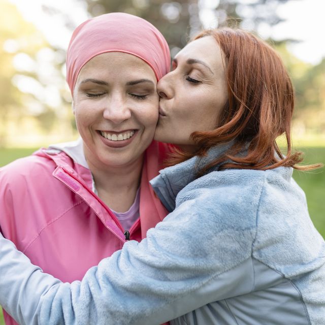 women hugging with closed eyes while kissing the fighter against cancer concept fight against breast cancer 