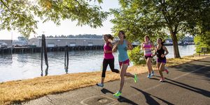Women jogging along coastline, Seattle, Washington, USA