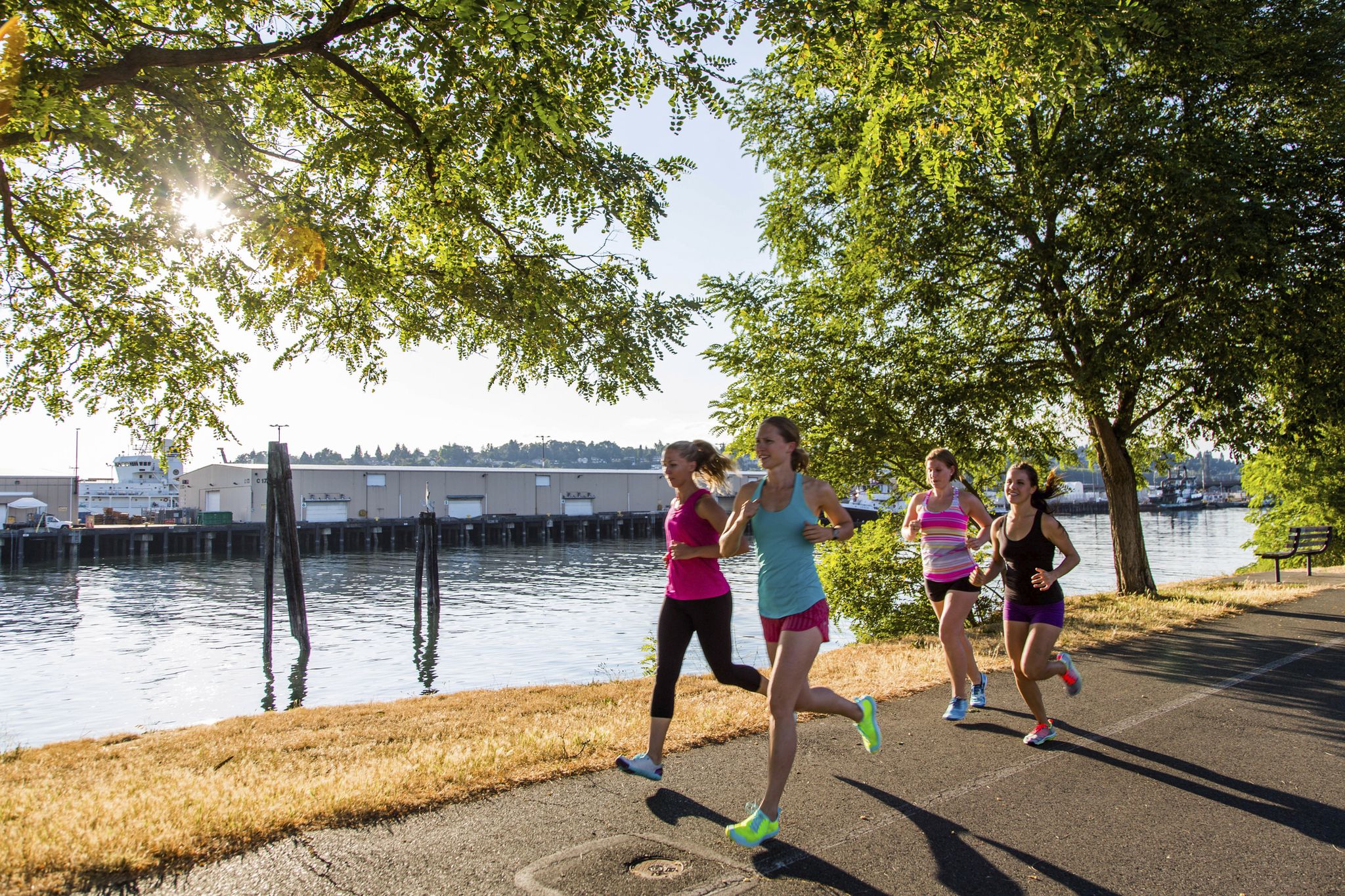 Women jogging along coastline, Seattle, Washington, USA