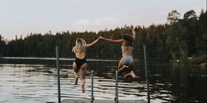 women jumping in the water