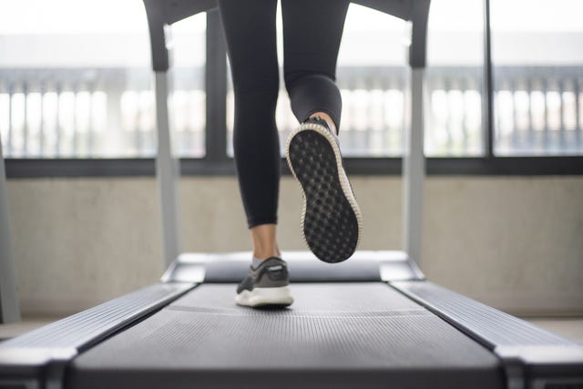 women legs running on treadmill at the fitness gym