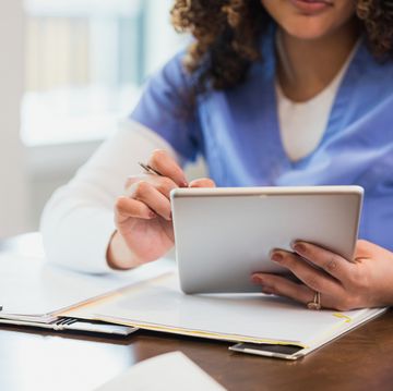 while working on a home healthcare case, a nurse uses a digital tablet add notes to a patients electronic medical chart