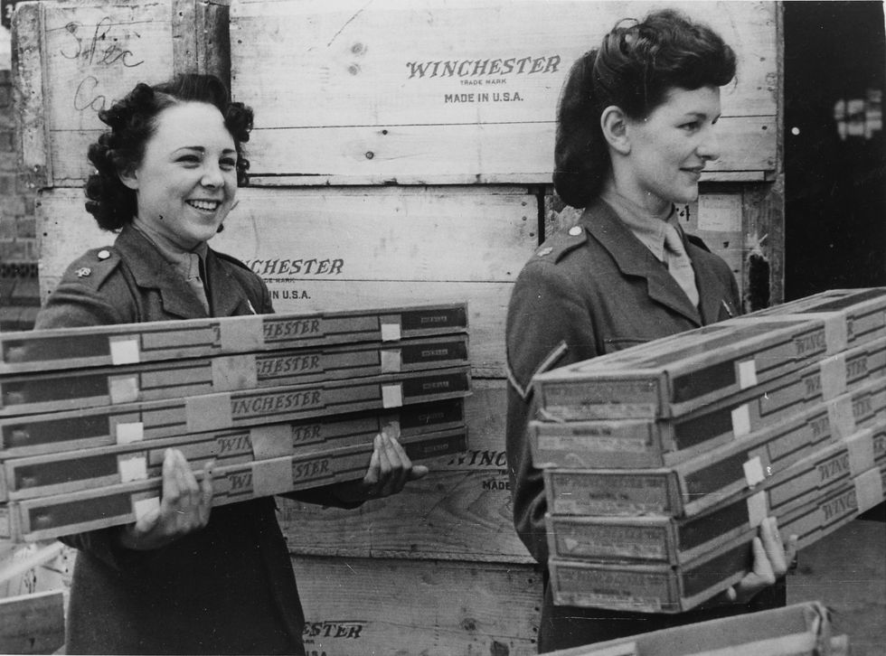 british women of the auxiliary territorial service unload a shipment of winchester rifles