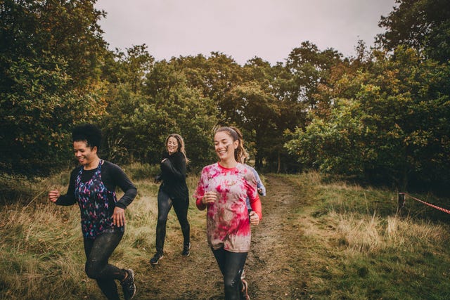 Women Running Through The Woods