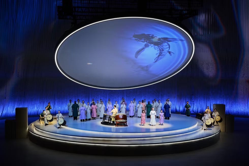 cultural performance on stage with traditional attire and instruments