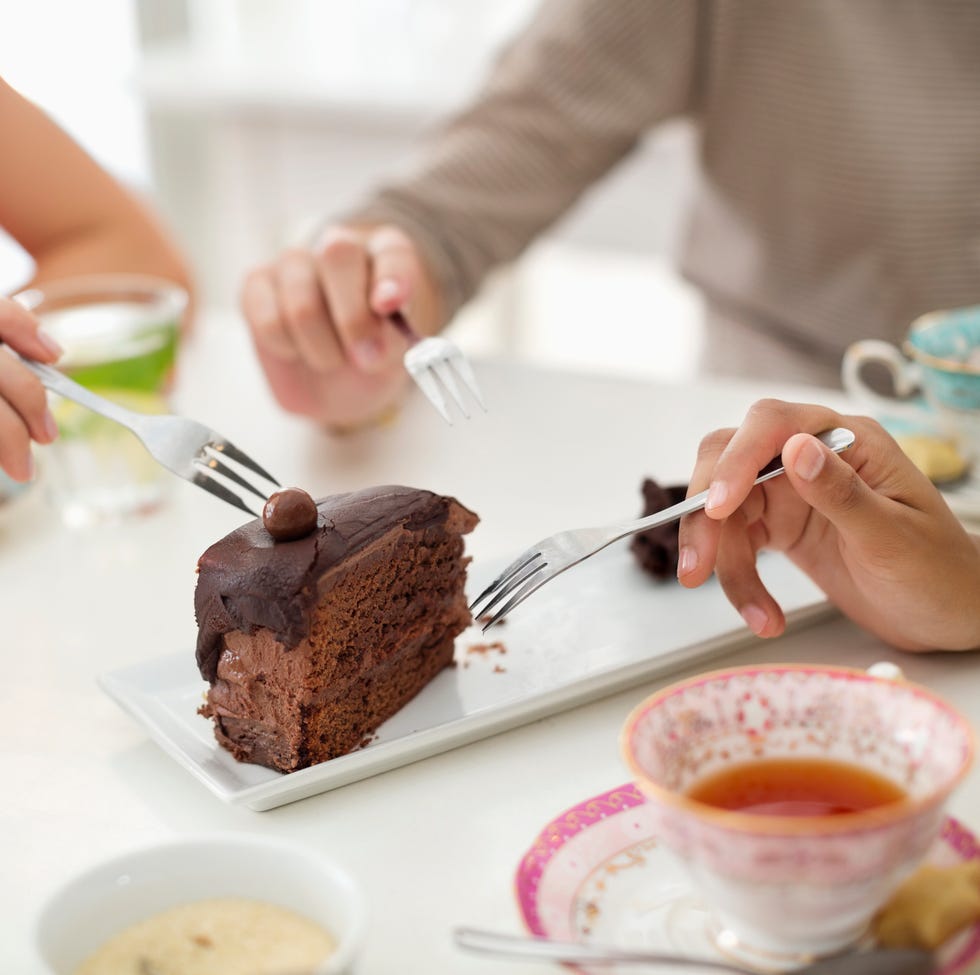Women sharing slice of cake Women sharing slice of cake