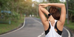 women stretching for warming up before running or working out young female runner stretching arms before running at morning fitness and healthy lifestyle concept