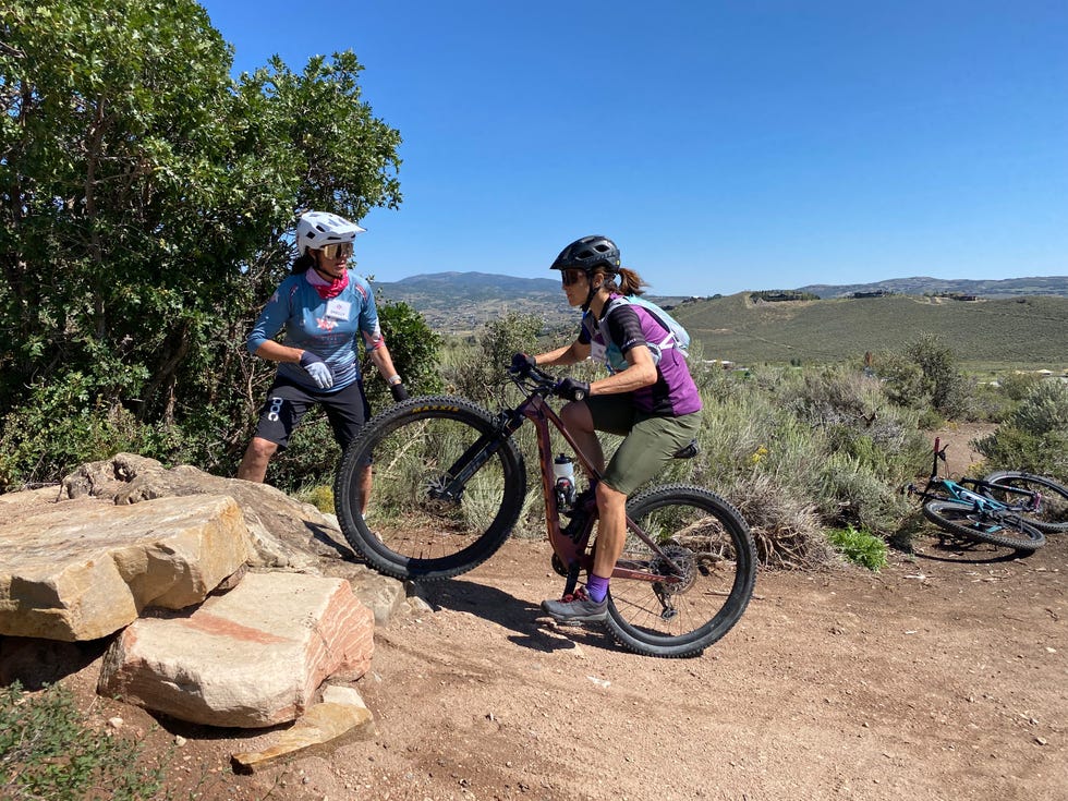 two people on a mountain bike at a women in mountains clinic