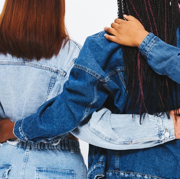 3 women in denim jackets with hands around each other