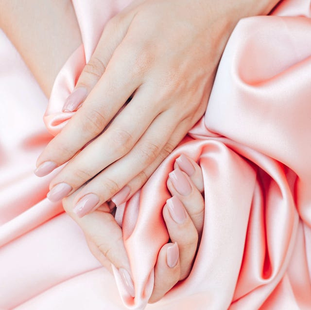 women's hands with a beautiful nude manicure