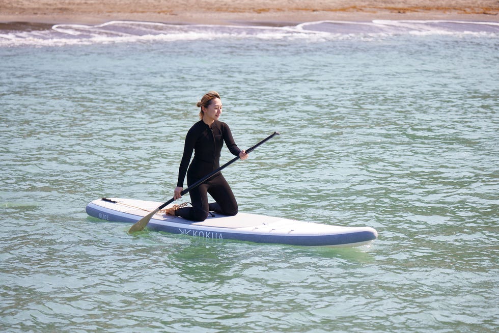 a man paddle boarding on the water